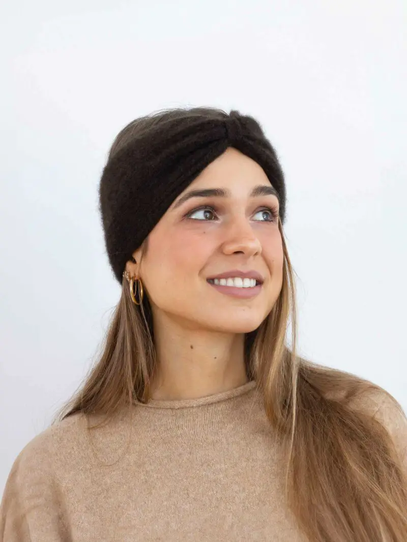 Femme souriante portant un bandeau cachemire torsade noeud marron en extérieur