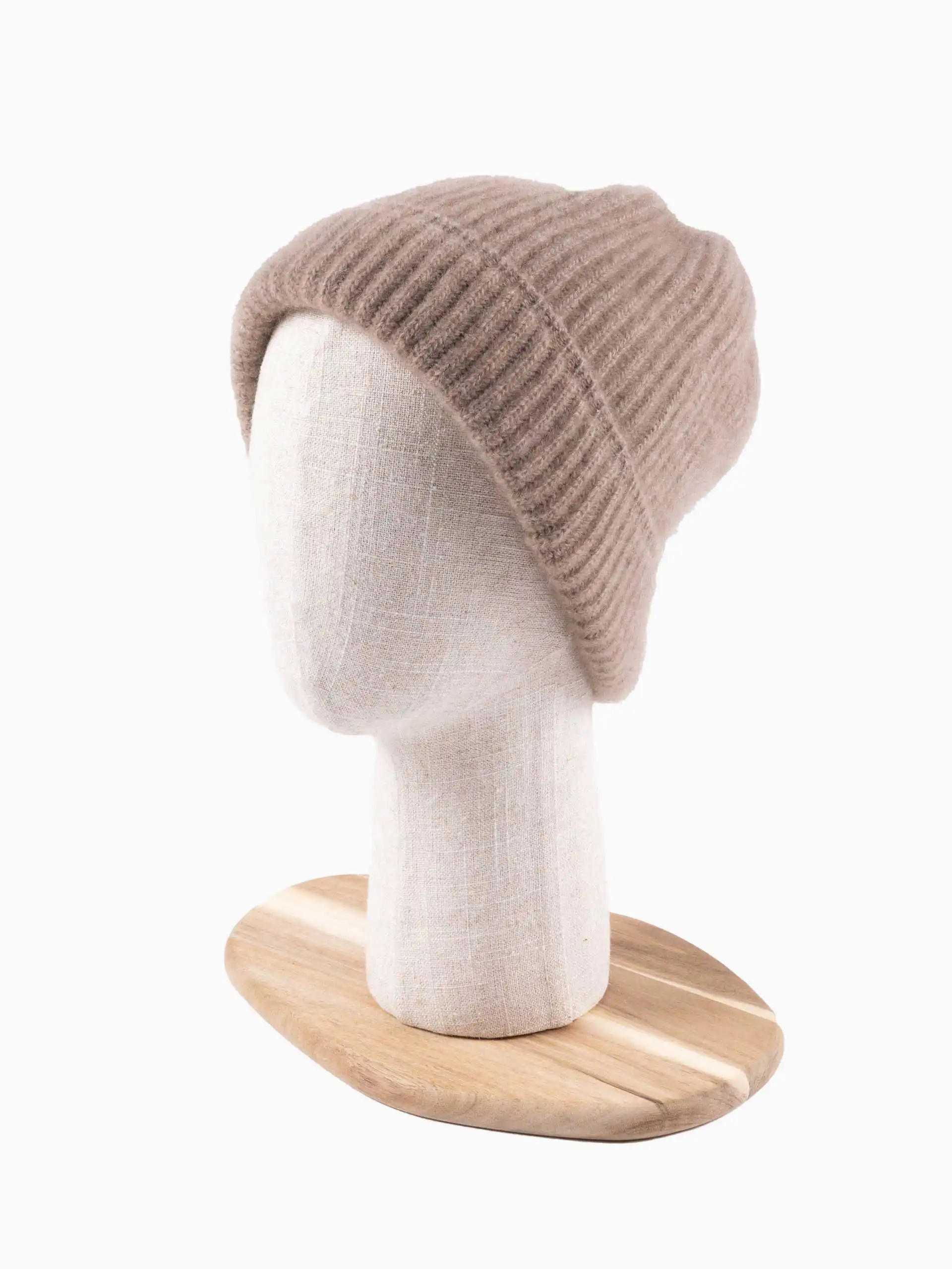 Bonnet en cachemire de couleur greige/grège élégant, présenté sur un mannequin en tissu avec socle en bois