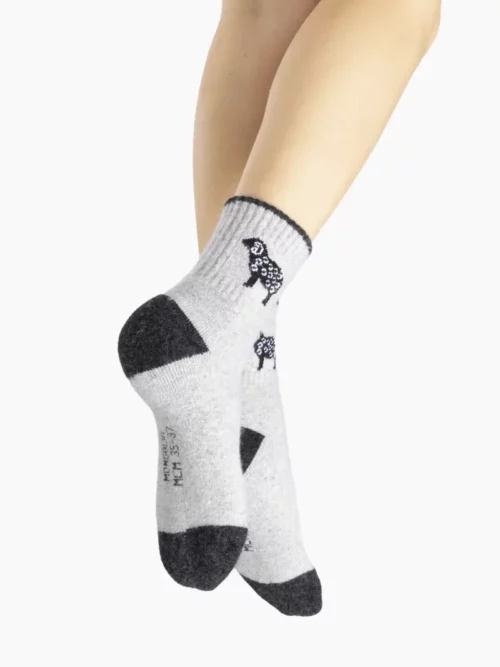 Une chaussette grise tricotée portée, mettant en valeur son motif et son confort pour homme et femme.
